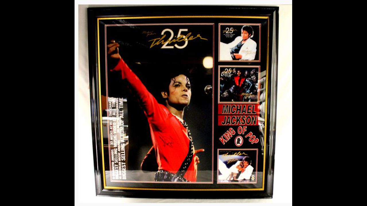 Framed and matted poster for 25th anniversary of "Thriller," autographed "Michael Jackson."