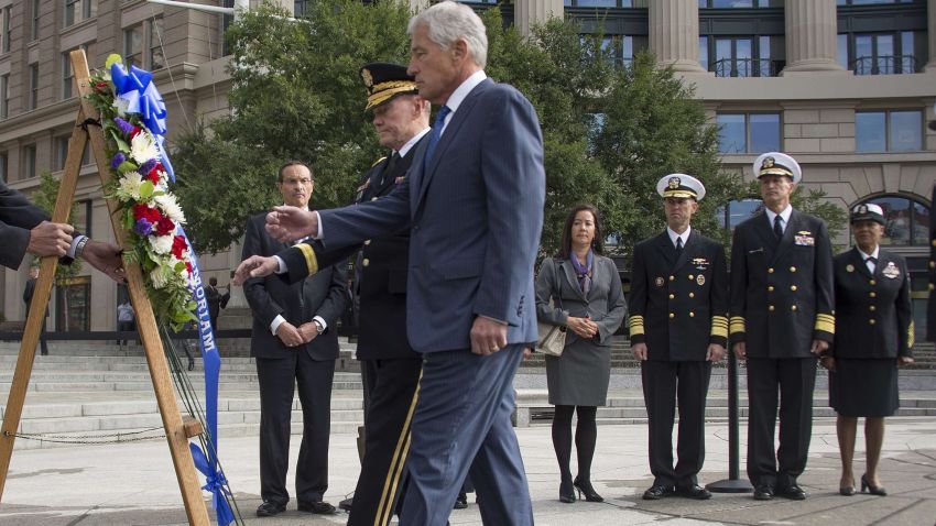 U.S. Defense Secretary Chuck Hagel and Chairman of the Joint Chiefs of Staff Gen. Martin Dempsey prepare to lay a wreath at the U.S. Navy Memorial plaza on Tuesday, September 13, 2013, in Washington, D.C., to honor the victims of the September 16 Washington Navy Yard shootings.