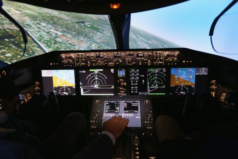Pilots train on one of two 787 full-flight simulators, like the one shown here, at the company's training center in Miami. Capt. Gary Lee Beard is shown demonstrating one of the simulators. 