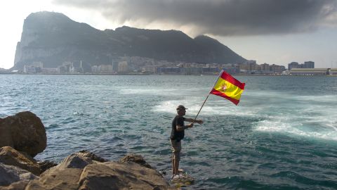 A fisherman holds a Spanish flag during a protest in the bay of Algeciras, near the Rock of Gibraltar, on August 18. 