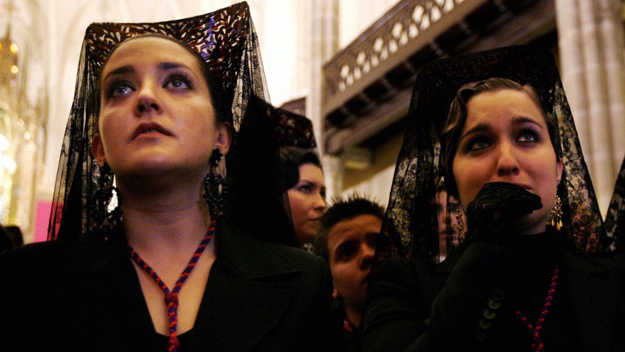 Women dressed in traditional mantillas wait in the church on April 4, 2007, for the start of the Cristo de los gitanos procession in Granada. 