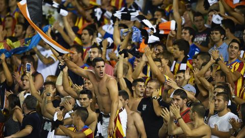 Valencia soccer fans cheer on their team during the La Liga match against FC Barcelona at Estadio Mestalla on September 1 in Valencia, Spain.  