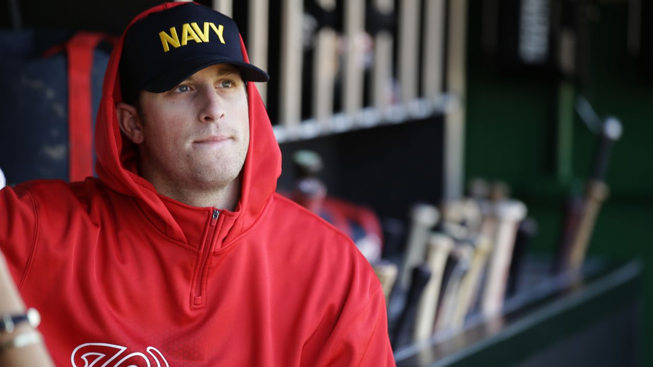Washington Nationals relief pitcher Ian Krol wears a Navy hat in the dugout of Nationals Park in Washington before a game against the Atlanta Braves on September 17.