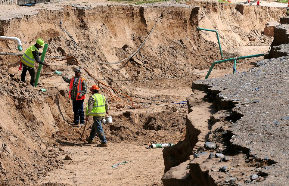 A construction crew begins work on multiple utility lines in a sinkhole in La Union, New Mexico, on Monday, September 16. Workers estimated the hole to be 13-feet deep and 30-feet wide. New Mexico declared a statewide disaster on September 13 because of widespread flooding. <a href="http://www.cnn.com/2013/09/12/us/gallery/colorado-flooding/index.html">View photos of severe flooding in Colorado.</a>