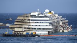A picture taken on September 17, 2013 shows the wreckage of Italy's Costa Concordia cruise ship which begins to emerge from water near the harbour of Giglio Porto.