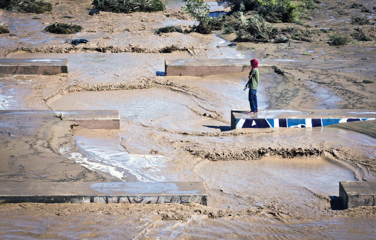 Christian Baste looks out at the flowing waters moving through the Swinburne Dam on the west side of Albuquerque, New Mexico, on September 13.