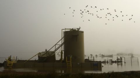 A gas well is surrounded by floodwater near Kersey, Colorado, on September 17.