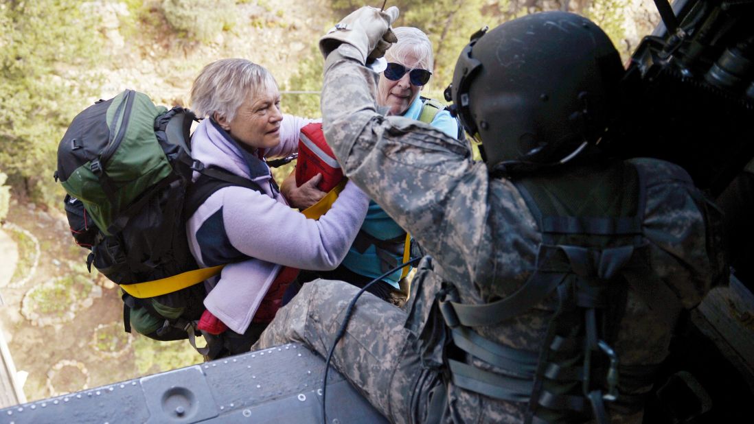 Two women are hoisted into a Blackhawk helicopter during a search and rescue mission near Jamestown, Colorado, on September 17.