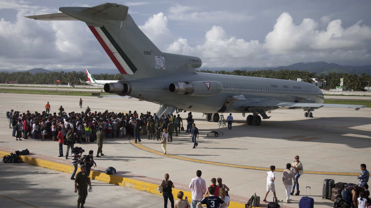 Stranded tourists gather around a Mexican air force plane at the air base in Pie de la Cuesta, near Acapulco, as they wait to be evacuated on September 17. An estimated 40,000 tourists were stranded in the Pacific state of Guerrero as dozens of roads were damaged and Acapulco's airport temporarily suspended services due to Hurricane Manuel.