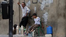 Young Syrian refugees and their father prepare coffee to sell in a street in Beirut on September 18, 2013. Some seven million people are in urgent need of humanitarian aid due to the conflict in Syria, a UN top official said, saying $4.4 billion (3.3 billion euros) is needed this year. AFP PHOTO/JOSEPH EID        (Photo credit should read JOSEPH EID/AFP/Getty Images)