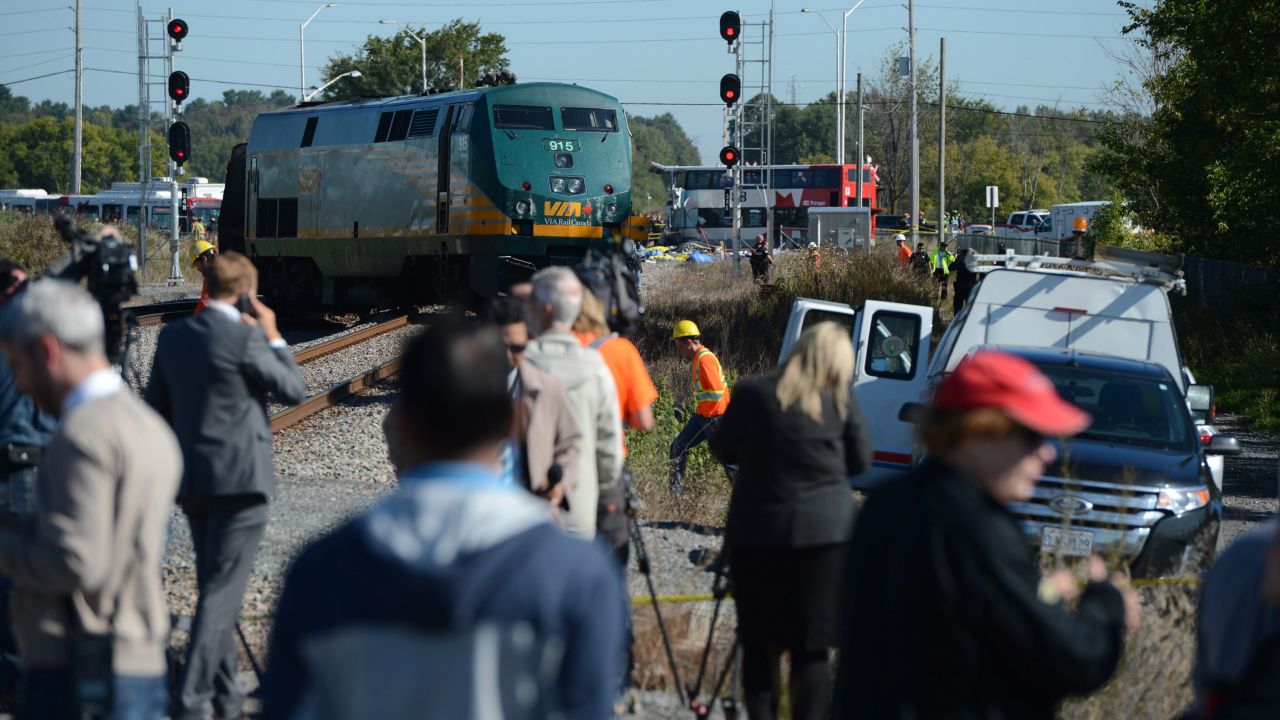 Members of the media watch as emergency crews respond to the crash on September 18.