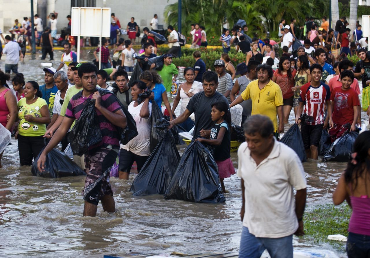 Residents carry goods and supplies in Acapulco on September 17.