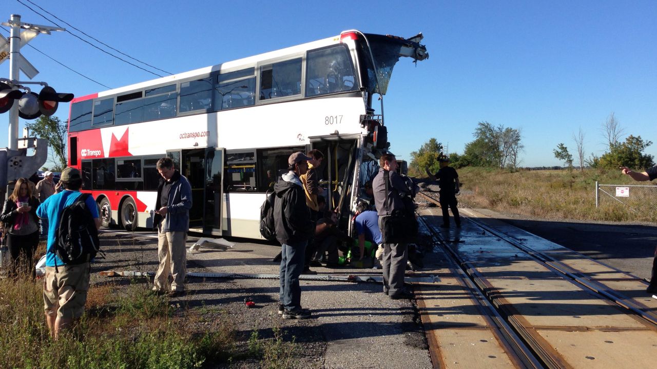 People stand next to the destroyed bus on September 18.