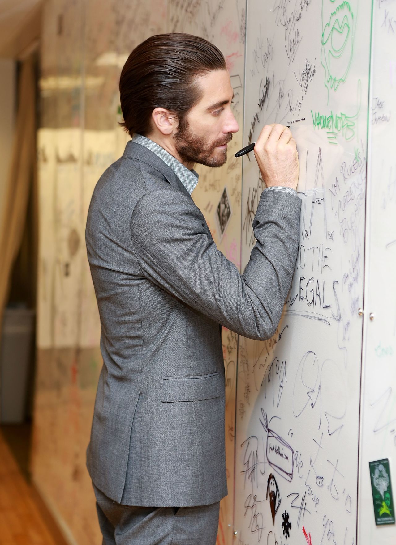 Jake Gyllenhaal signs his name while visiting SiriusXM on September 18.