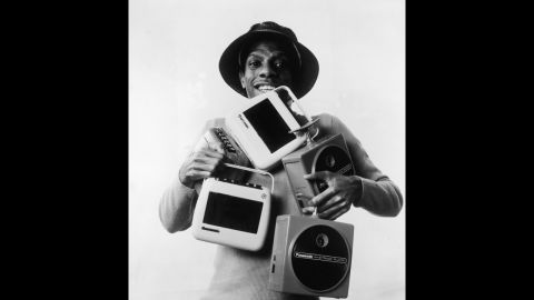 The cassette was introduced in 1963; the 8-track tape in 1964. Both were portable ways of listening to music. Here, actor Jimmie Walker (as his "Good Times" character J.J.) poses with several 8-track and cassette players.