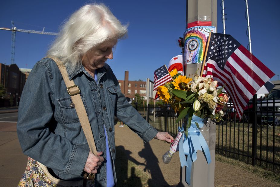 A woman who said she works at the Washington Navy Yard looks at a memorial to the shooting victims on Wednesday, September 18. Authorities said 12 people -- plus the gunman -- were killed in the shooting on Monday, September 16. <a href="http://www.cnn.com/2013/09/16/us/gallery/navy-yard-shooting/index.html">View photos from the scene of the rampage.</a>