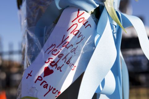 A handwritten note is taped to a post across the street from the Washington Navy Yard on September 18.