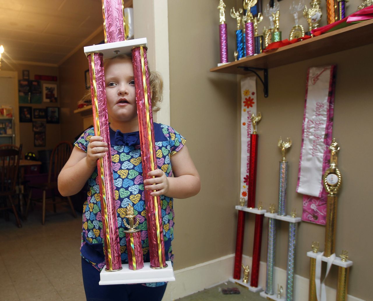 Alana "Honey Boo Boo" Thompson became a household name after the now 8-year-old beauty pageant regular, seen here showing off one of her many pageant trophies, starred in her own reality show set in her rural hometown of McIntyre, Georgia.