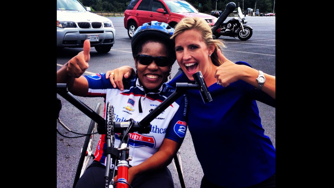 Daniel celebrates riding 26 miles for "Ride 2 Recovery" with CNN's Poppy Harlow.