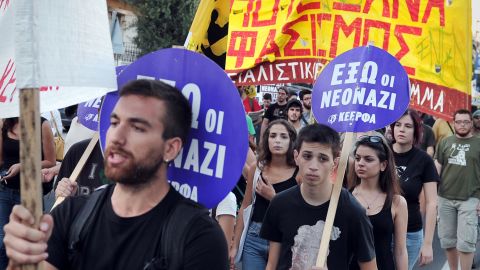 Anti-fascist protesters hold signs reading "Neo-Nazis Out" at a rally in Athens on Wednesday.