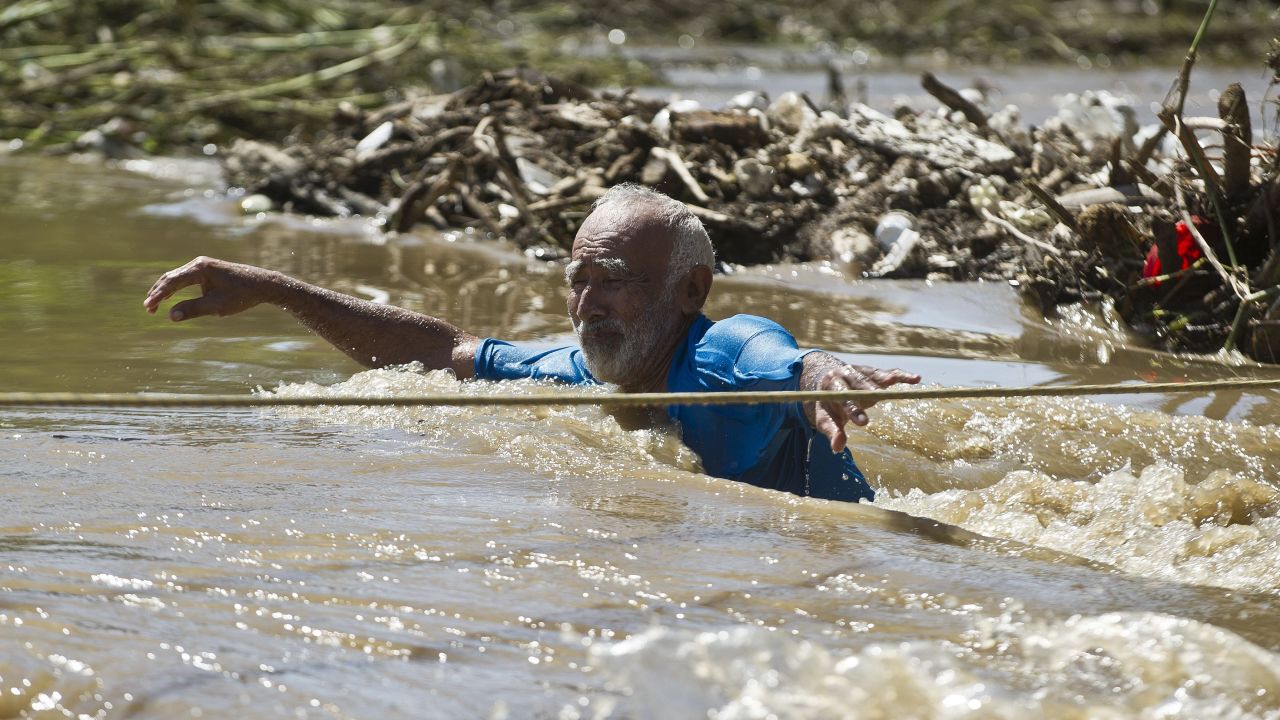 A man wades through floodwaters in Acapulco on September 18.