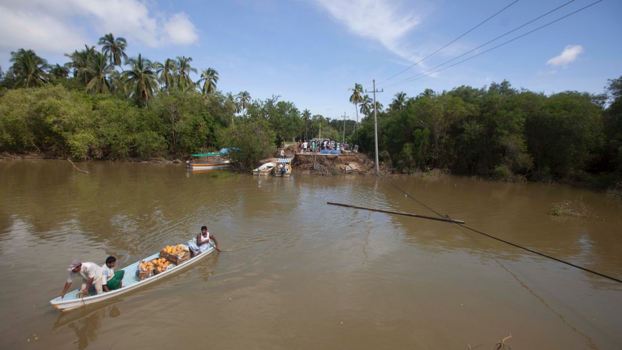 A boat moves across the Papagayo River to ferry people from the end of a collapsed bridge in Acapulco on September 18.