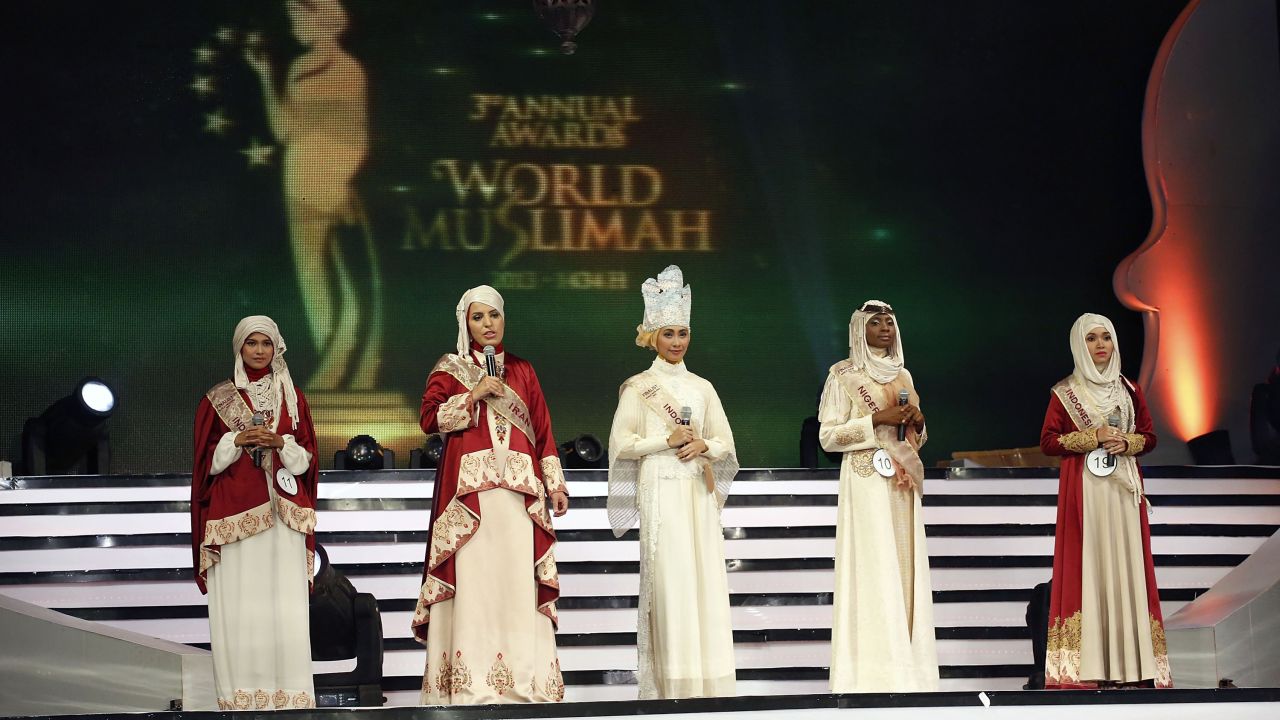 Women speak on stage during the competition.