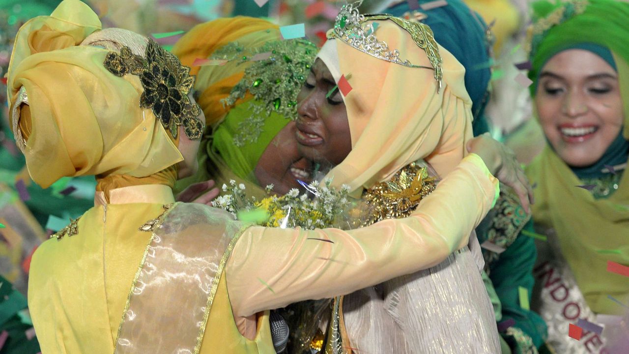 Ajibola is congratulated by contestants after being crowned World Muslimah 2013.
