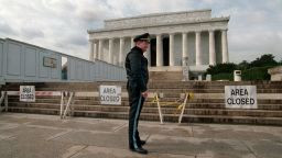 A Park Service police officer stands guard in front of the Lincoln Memorial during a partial shutdown of the federal government on November 15, 1995.
