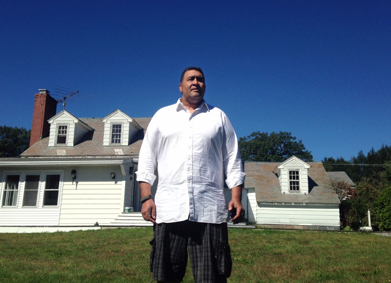 Former NFL offensive lineman Brian Holloway stands in front of his rural vacation home on Wednesday, September 18, in Stephentown, New York. Holloway's rural vacation home was trashed during a Labor Day weekend party attended by about 300 teenagers. 