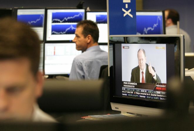 As finance minister of the Eurozone's largest economy, Steinbrueck was the mastermind behind Germany's bank rescue plan. Here, traders at the Frankfurt stock exchange listen to a statement by Steinbrueck during the financial crisis in October 2008.