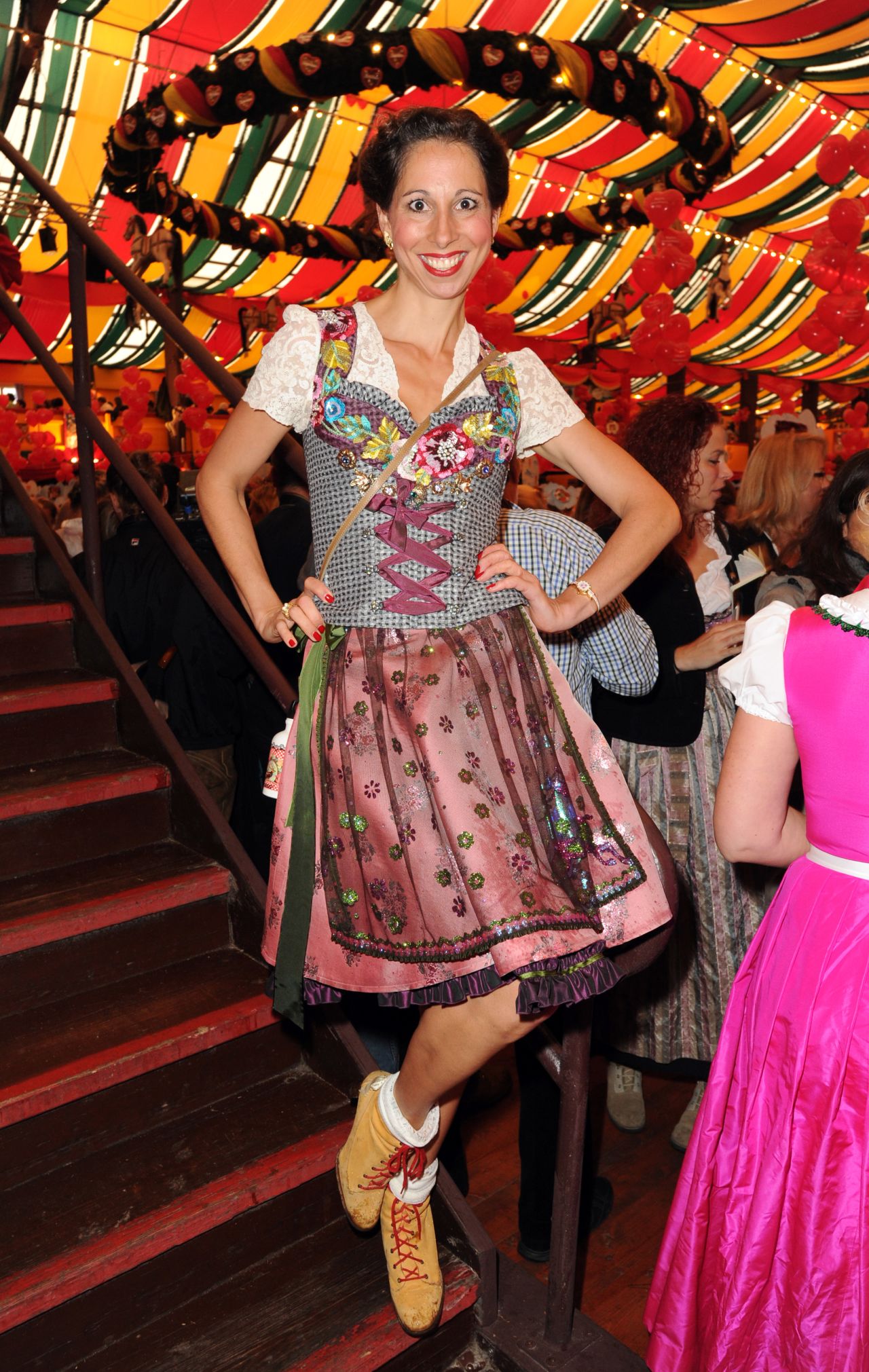 A tent isn't just a tent at Oktoberfest, but a sign of your personality type. Celebrities of various grades gather at the Hippodrom tent -- here a German designer of trad Bavarian wears what looks like a floral spaceship landing on her head. 