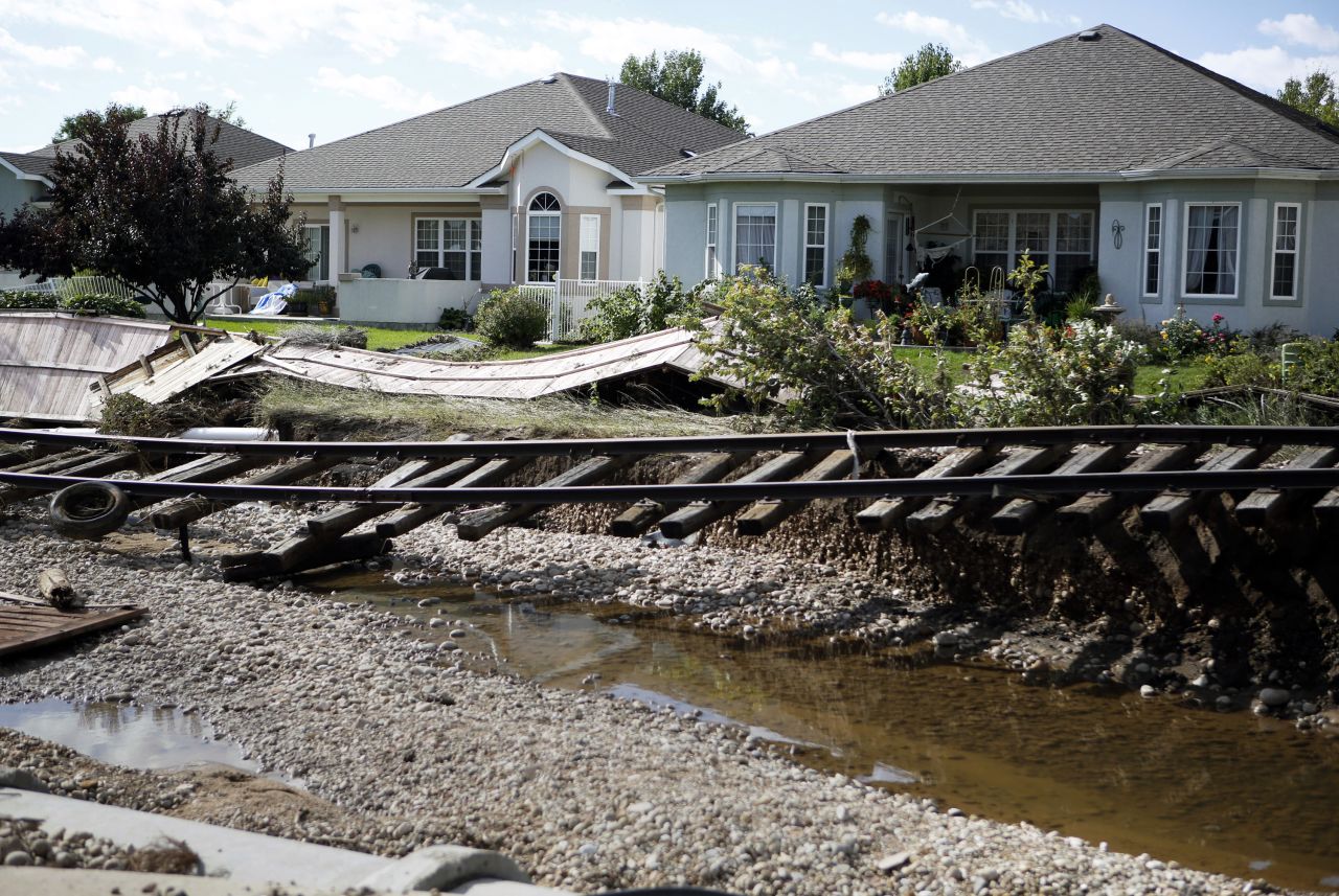 Railroad tracks washed from their path by floodwaters are seen in Longmont on Thursday, September 19, 2013.  Massive flooding has left at least six people dead and damaged thousands of homes around the state.