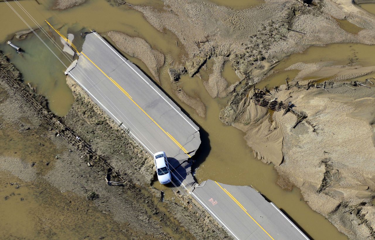 An abandoned car sits on a destroyed road along the South Platte River near Greeley, Colorado, on September 17.