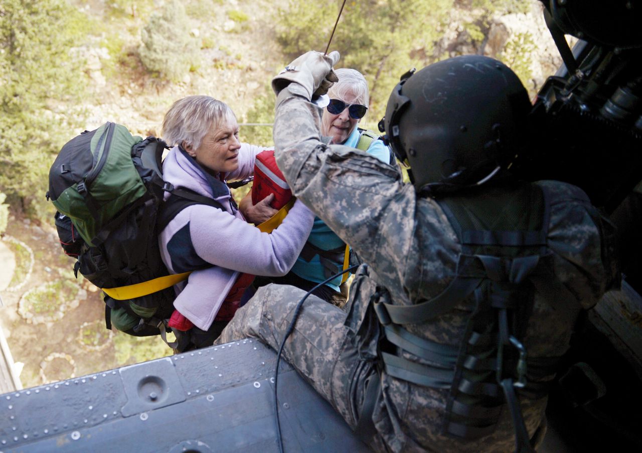 On September 17 two women are hoisted into a Blackhawk helicopter during a search and rescue mission near Jamestown, Colorado.