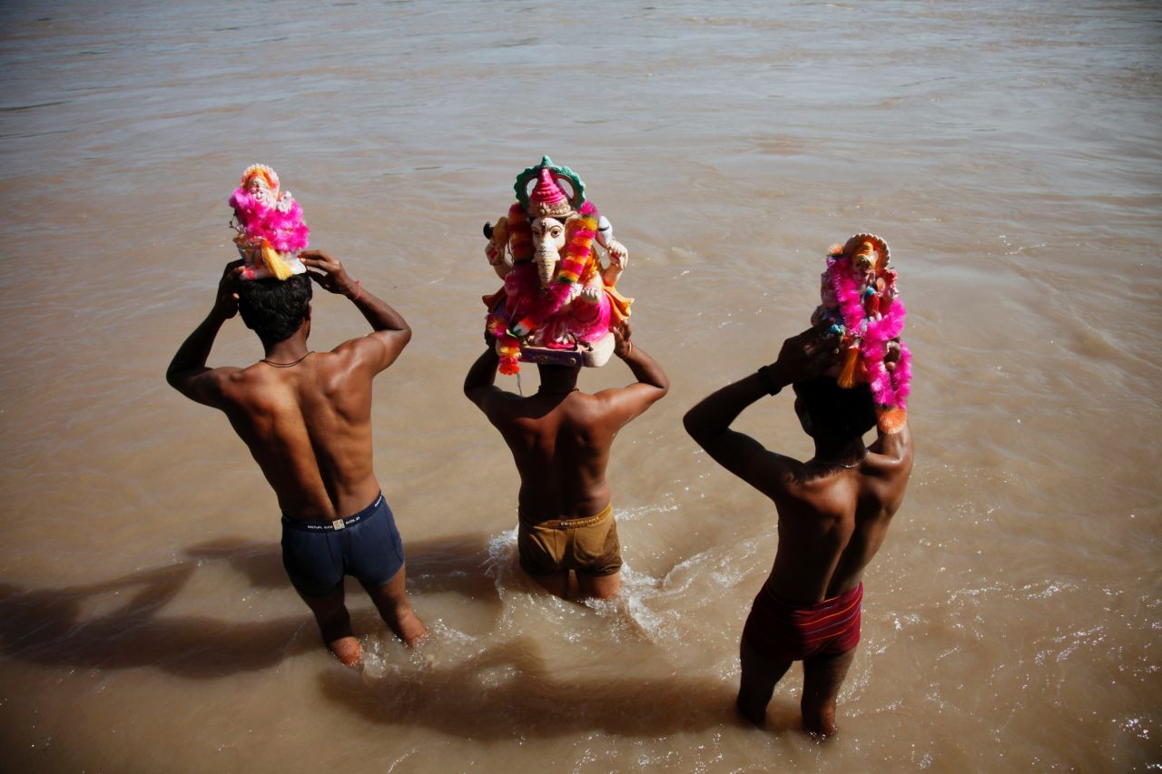 Indian devotees prepare to immerse idols of elephant-headed Hindu god Ganesha on Monday, September 16 in the Chenab River during Ganesh Chaturthi festival celebrations in Akhnoor, India.