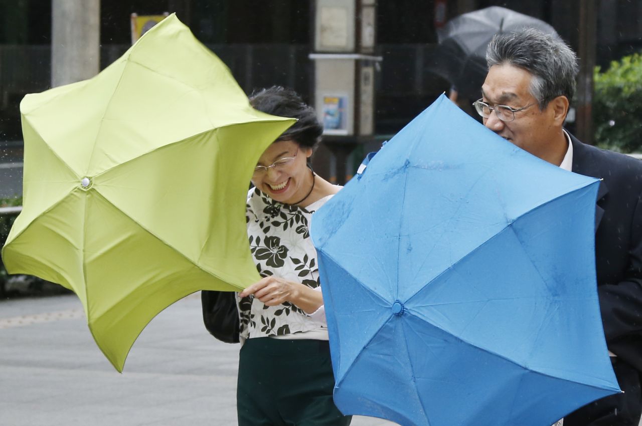 Pedestrians struggle to hold their umbrellas as a powerful typhoon approaches Tokyo, Japan, on September 16.
