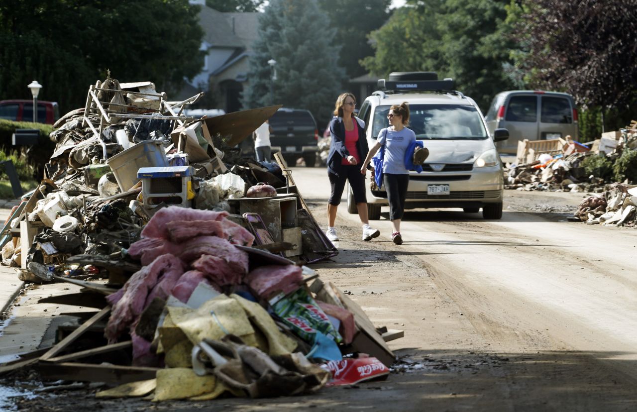 Piles of items destroyed by flooding line both sides of a street in Longmont on September 19. 