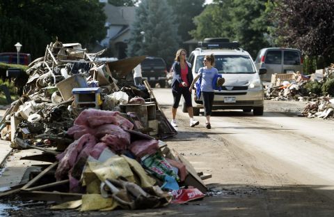 Piles of items destroyed by flooding line both sides of a street in Longmont on September 19. 