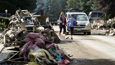 Piles of items destroyed by flooding line both sides of a street in Longmont on September 19.
