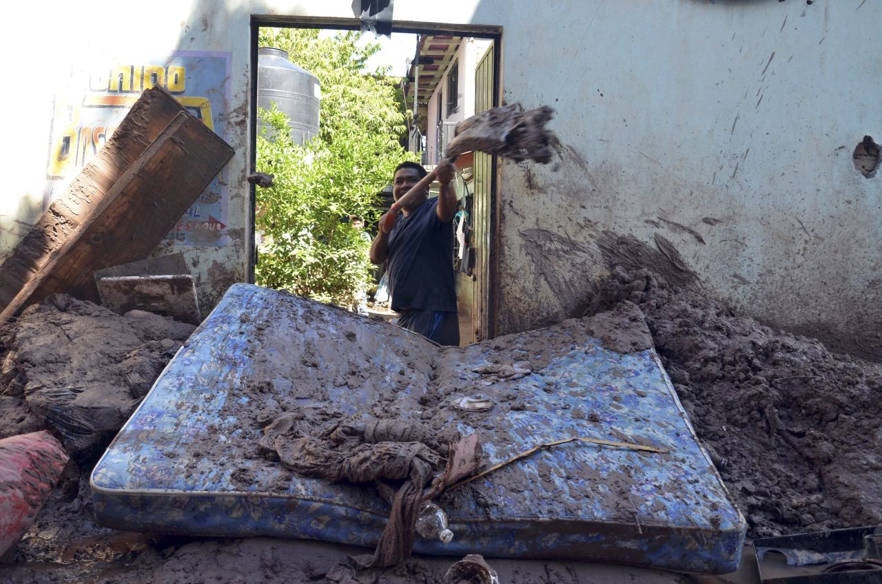 A man shovels mud from his home on September 19 in Chilpancingo, Guerrero.