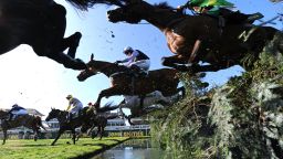 Fine Parchment (C) ridden by jockey Peter Toole jumps over the 'Water Jump' during the John Smiths Topham Steeple chase on the second day of the Grand National meeting at Aintree Racecourse in Liverpool, north-west England on April 8, 2011.
