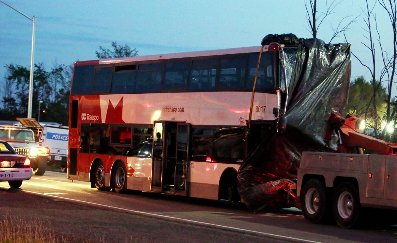 An Ottawa, Ontario, double-decker bus plowed into a moving train on Wednesday, September 18, in a horrific morning crash that left six dead and at least 34 others injured. The bus is towed away from the site of the crash on Thursday, September 19. Click through for more images from the crash: