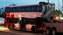 A bus is towed away from the site of the fatal bus and train crash in Ottawa, Ontario, on Thursday, Sept. 19, 2013. Police are seeking clues as to why the bus crashed through a safety barrier and slammed into a Via Rail train killing six people on Wednesday Sept. 18. (AP Photo/The Canadian Press, Fred Chartrand)