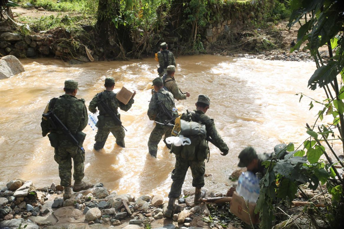 Members of the military try to move aid to Atoyac de Alvarez, which is isolated because of flooding on September 19.