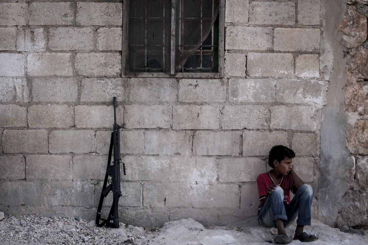 A Syrian child sits in a village in the Idlib province countryside on September 19. 