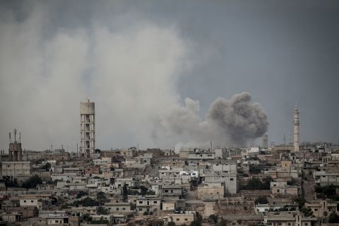 Smoke rises after a bomb was thrown from a helicopter, hitting a rebel position during heavy fighting between troops loyal to Syrian President Bashar al-Assad and opposition fighters in the Idlib province on September 19.
