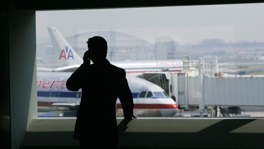 NEW YORK - JULY 27: A man talks on a cell phone in the new American Airlines terminal at John F. Kennedy International Airport July 27, 2005 in New York City. The new, 1.1 billion dollar termninal is the largest to house a single airline at JFK and can process nearly 2000 passengers an hour, according to the airline.