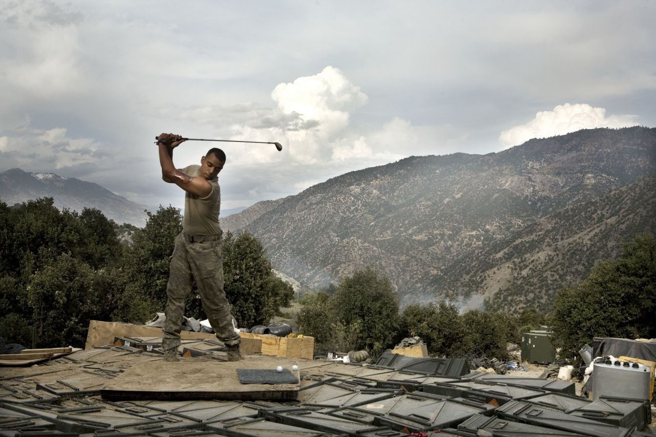 Before his death in 2011, British-American photographer Tim Hetherington spent time taking pictures of a US contingent of soldiers establishing an outpost in northeastern Afghanistan. Now on display at the <a href="http://www.openeye.org.uk/main-exhibition/tim-hetherington-you-never-see-them-like-this/" target="_blank" target="_blank">Open Eye gallery in Liverpool,</a> Hetherington's work explores how these soldiers cope with their emotionally draining existence -- in this case by playing on a makeshift driving range. 