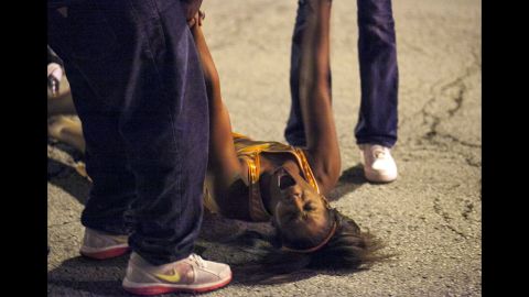 A woman is overcome with emotion near the scene of the shooting at Cornell Square Park in Chicago's Back of the Yard neighborhood on September 19.